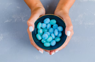 A hand holding Blue lutos gummies